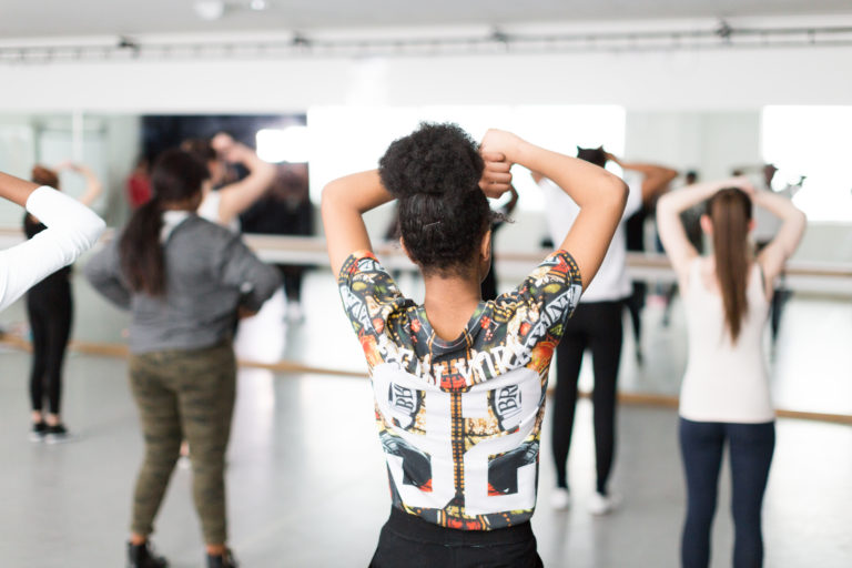 Women taking part in a dance class in an indoor fitness suite