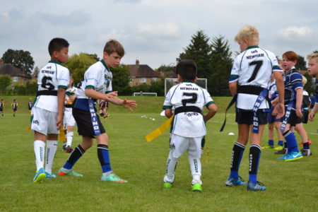 Young rugby players playing tag rugby
