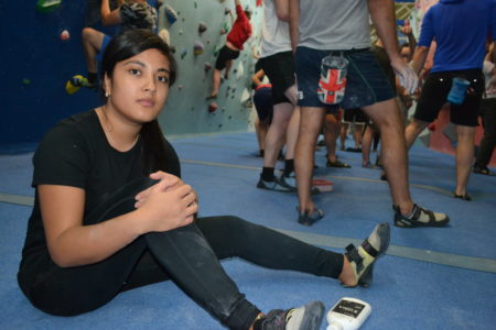 Young woman in an indoor climbing venue.