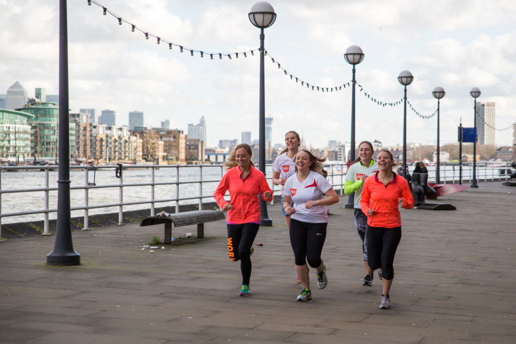 Female runners running alongside the Thames