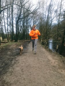 runner in woods with dog