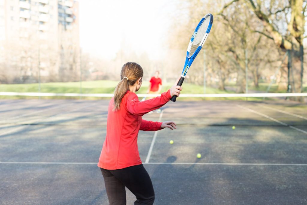 Woman playing tennis on an outdoor court
