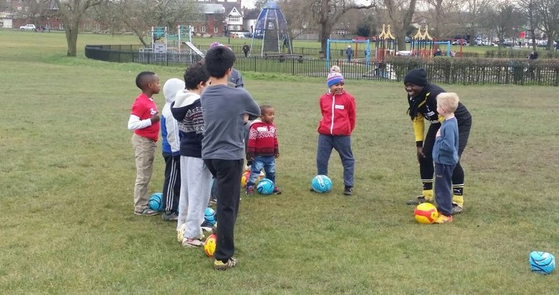 Diverse group of children learning to play football during ABCD Project
