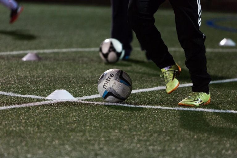 Young football player on astro turf pitch