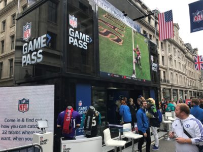 Big screen showing highlights of NFL game during NFL at Regent Street