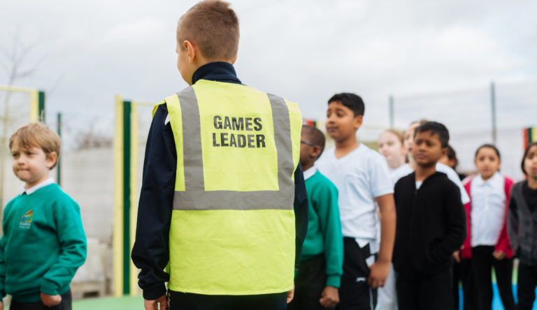 Young children doing physical activity during school coordinated by school leader