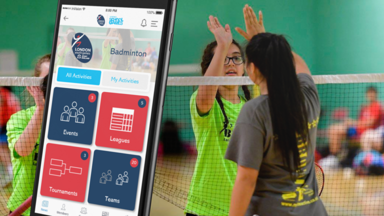 Young people playing sport in an indoor facility, with a mobile Playwaze app in the foreground