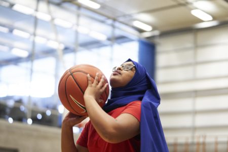 Girl shooting basketball