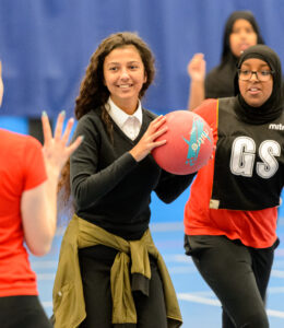 School girls play netball together