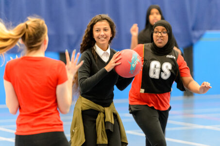 School girls play netball together
